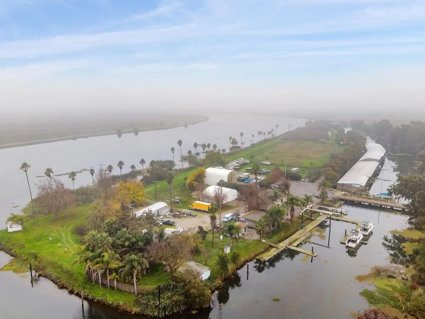 Aerial view of marina and waterways with boats and palm trees