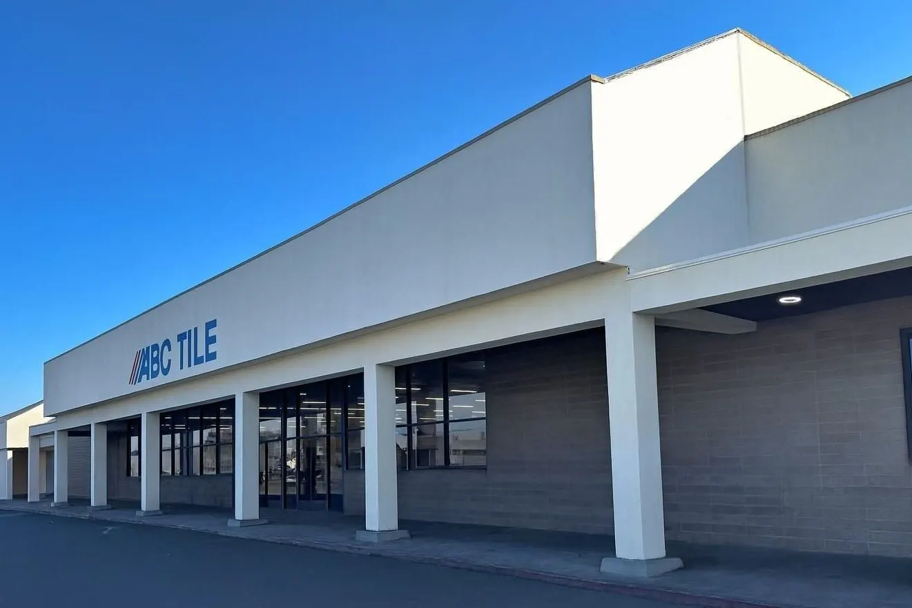Commercial building with ARCO Tile sign under a clear blue sky